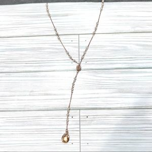 Gold tone long faux pearl necklace